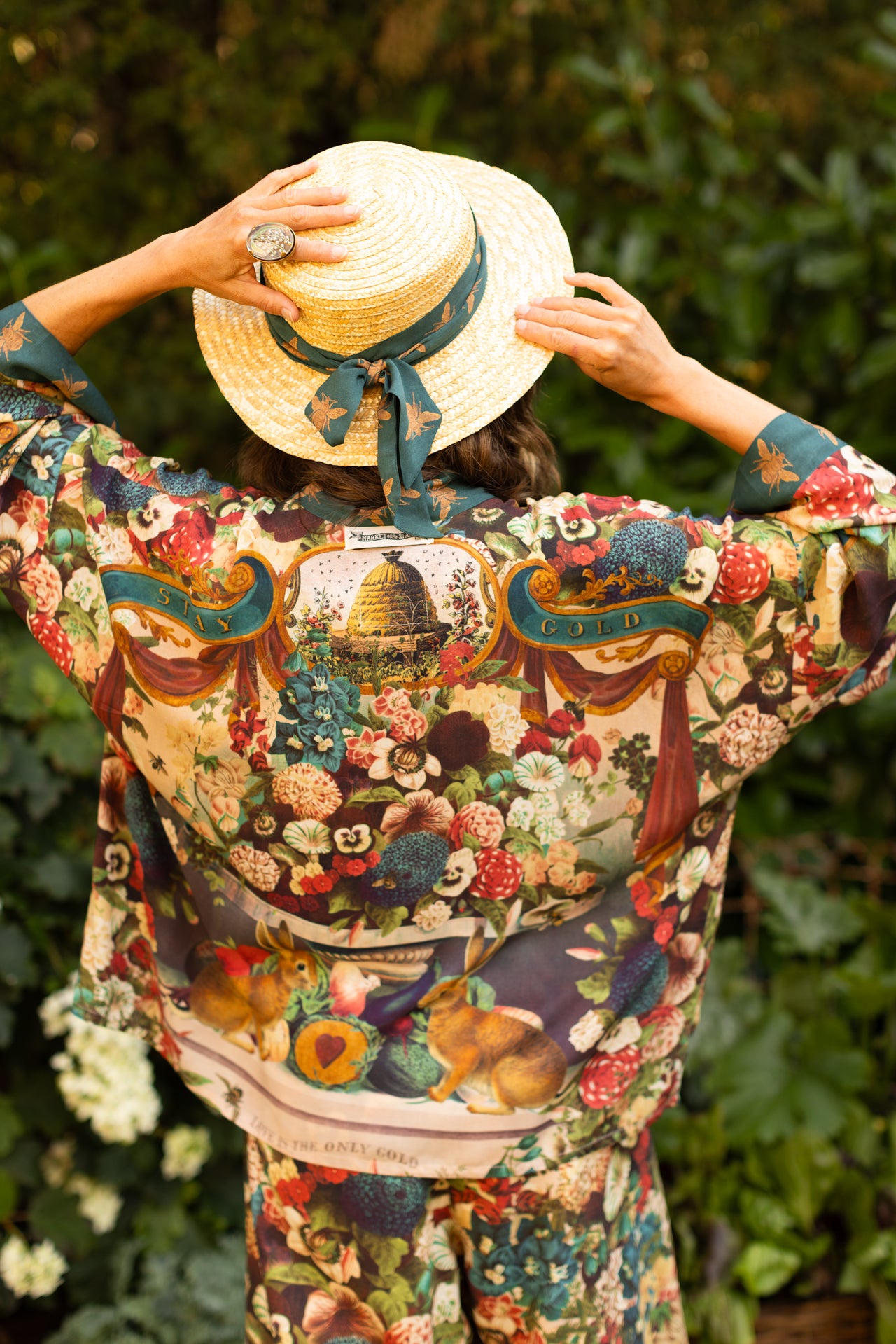 Model wearing Stay Gold Pixie Duster featuring wildflowers, bees, bunny rabbits and poetic vintage collage in cropped length – Market of Stars