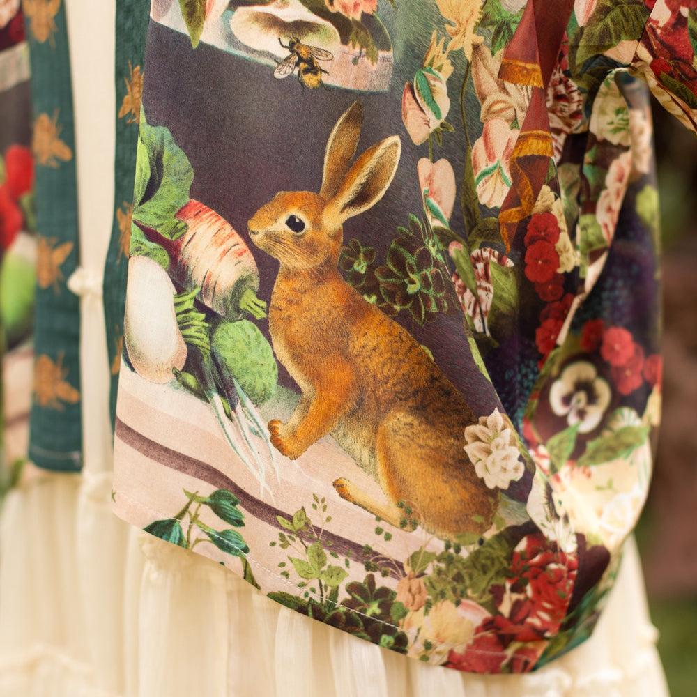 
                  
                    Model wearing Stay Gold Pixie Duster featuring wildflowers, bees, bunny rabbits and poetic vintage collage in cropped length – Market of Stars
                  
                