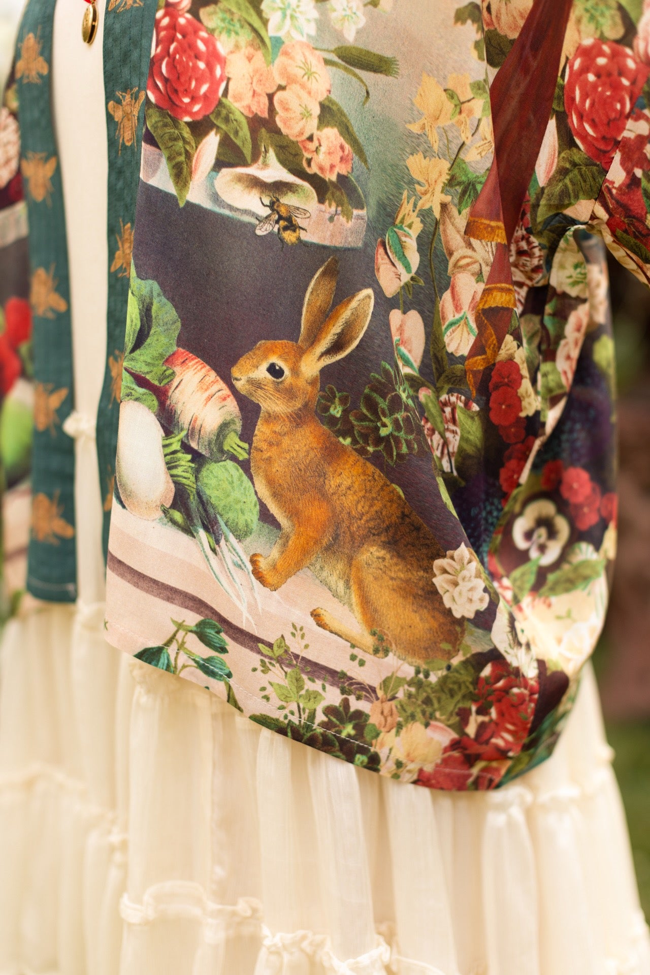Model wearing Stay Gold Pixie Duster featuring wildflowers, bees, bunny rabbits and poetic vintage collage in cropped length – Market of Stars