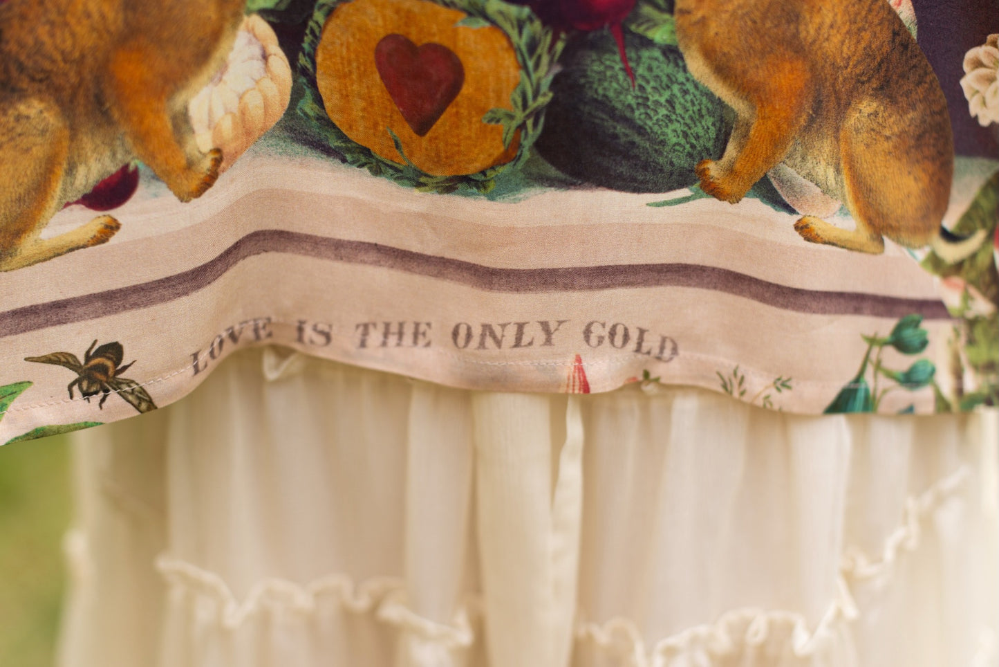 Model wearing Stay Gold Pixie Duster featuring wildflowers, bees, bunny rabbits and poetic vintage collage in cropped length – Market of Stars