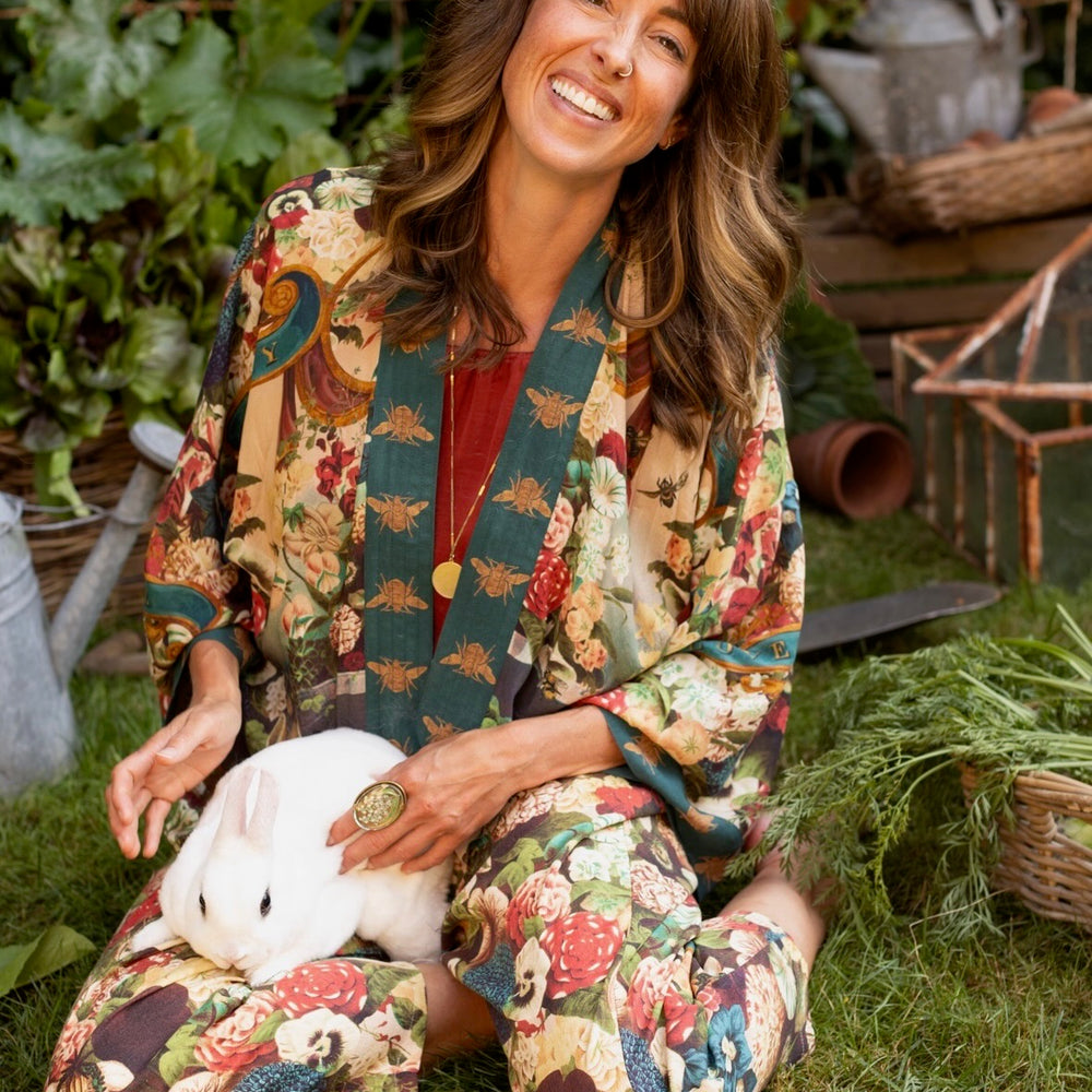 
                  
                    Model wearing Stay Gold Pixie Duster featuring wildflowers, bees, bunny rabbits and poetic vintage collage in cropped length – Market of Stars
                  
                
