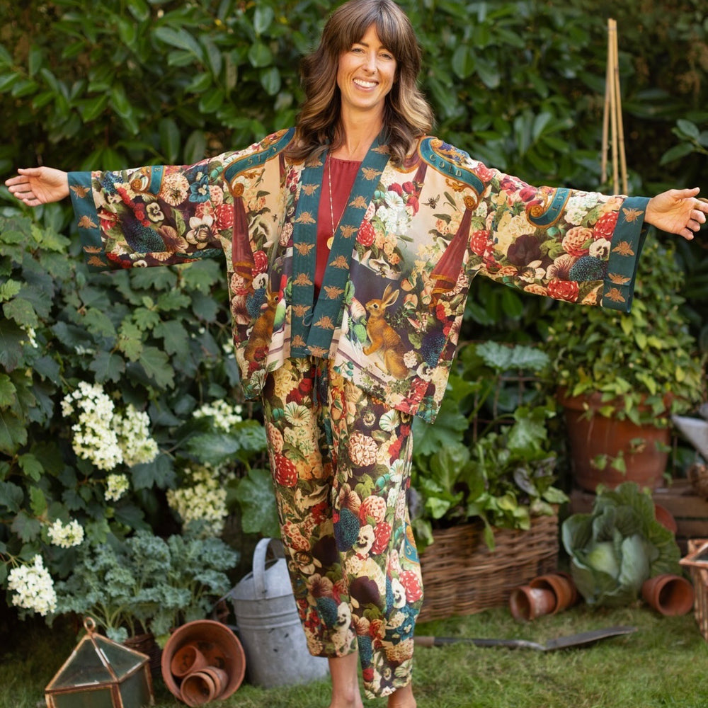 
                  
                    Model wearing Stay Gold Pixie Duster featuring wildflowers, bees, bunny rabbits and poetic vintage collage in cropped length – Market of Stars
                  
                