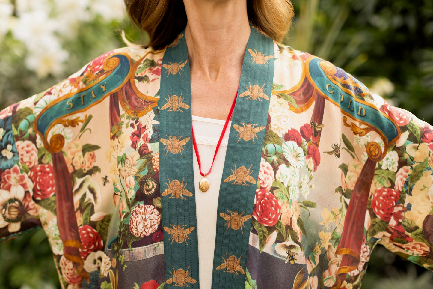 Model wearing Stay Gold Pixie Duster featuring wildflowers, bees, bunny rabbits and poetic vintage collage in cropped length – Market of Stars