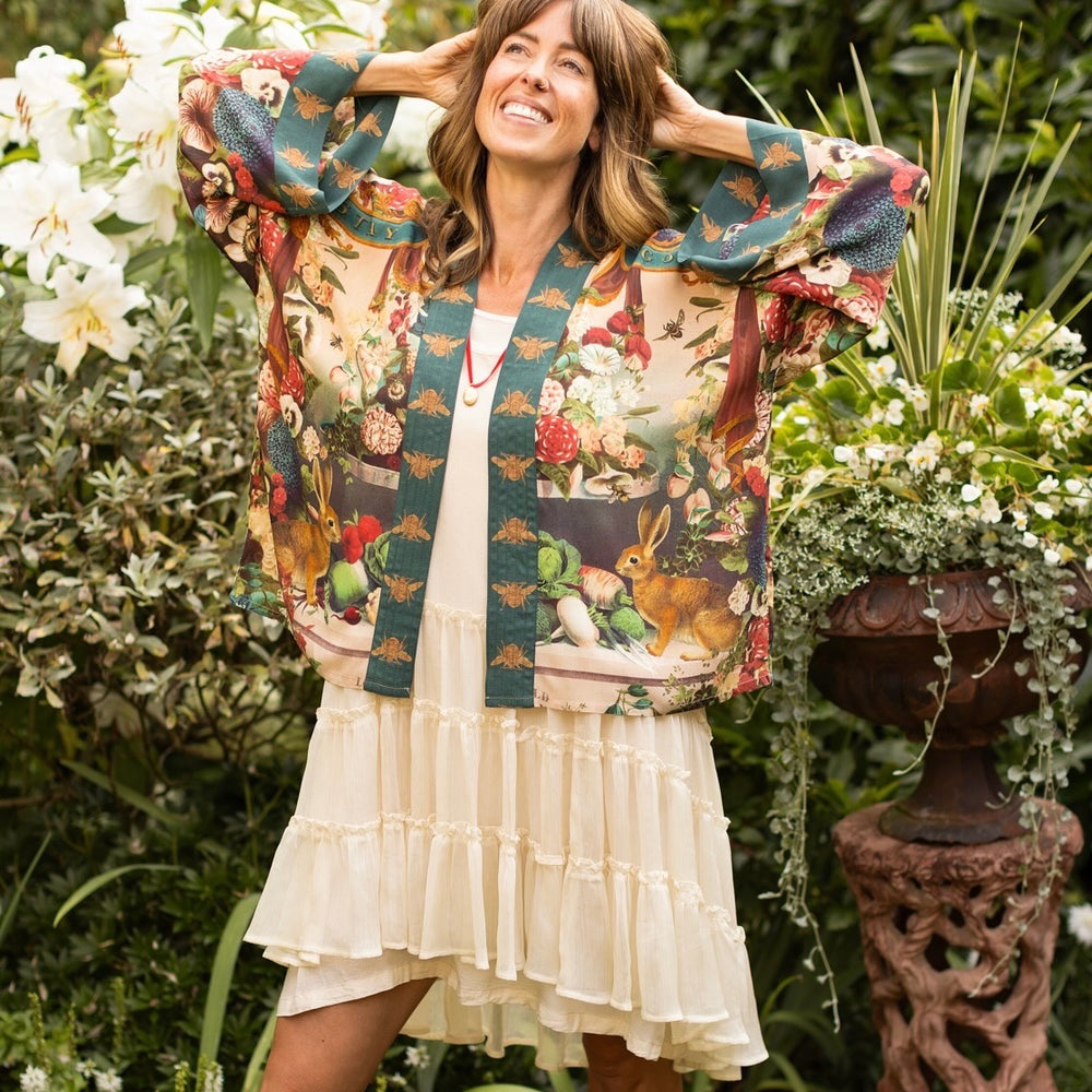 
                  
                    Model wearing Stay Gold Pixie Duster featuring wildflowers, bees, bunny rabbits and poetic vintage collage in cropped length – Market of Stars
                  
                