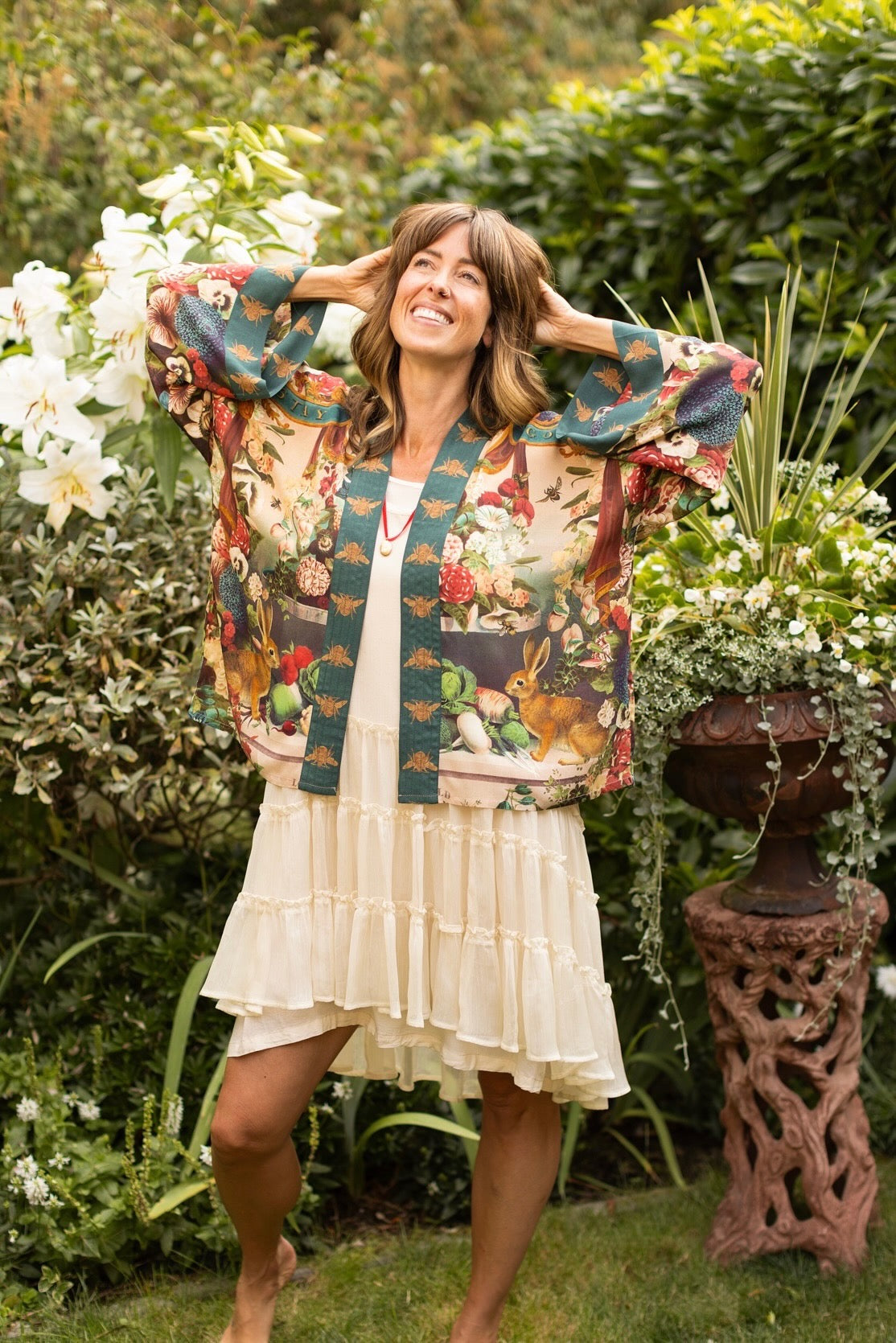 Model wearing Stay Gold Pixie Duster featuring wildflowers, bees, bunny rabbits and poetic vintage collage in cropped length – Market of Stars