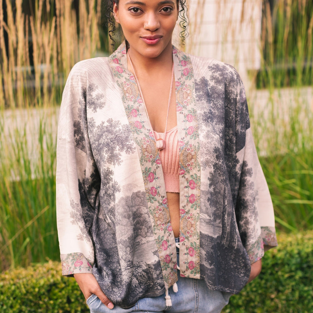 Model wearing our Still I Rise Pixie Duster with empowering message a bold, layered design featuring antique landscape etchings – Market of Stars