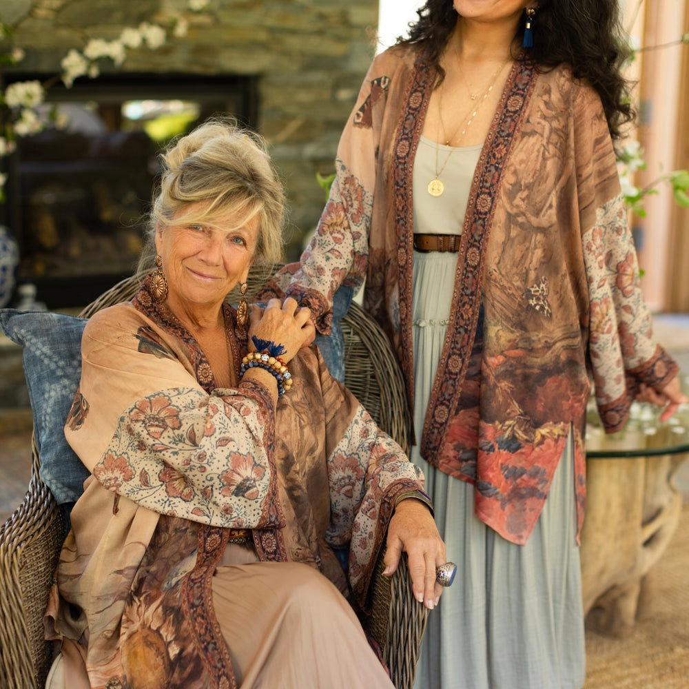 Model(s) wearing The Storyteller -- a mid-length Matinée kimono duster featuring antique artwork and vintage prints from around the world -- Market of Stars