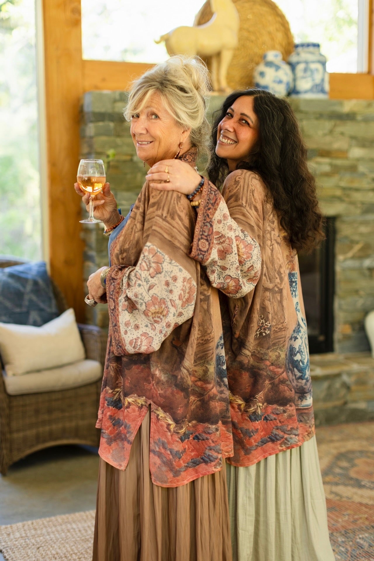 Model(s) wearing The Storyteller -- a mid-length Matinée kimono duster featuring antique artwork and vintage prints from around the world -- Market of Stars