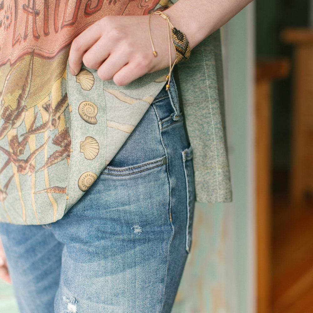 
                  
                    Soft bamboo-based tee featuring antique nautical artwork with shells, sunshine, and mermaid – Market of Stars
                  
                