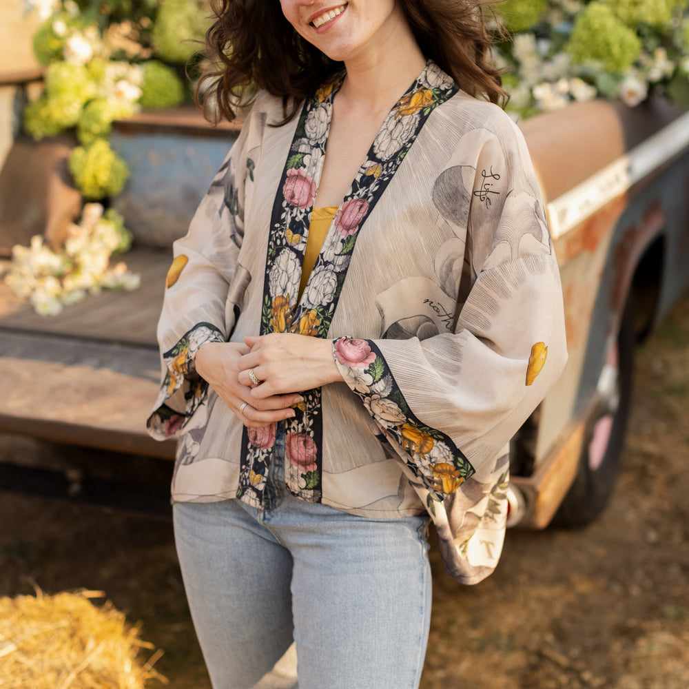 A joyful blend of 17th-century engravings, painted hearts, and hand-coloured florals on our cropped Take My Hand Pixie duster kimono – Market of Stars