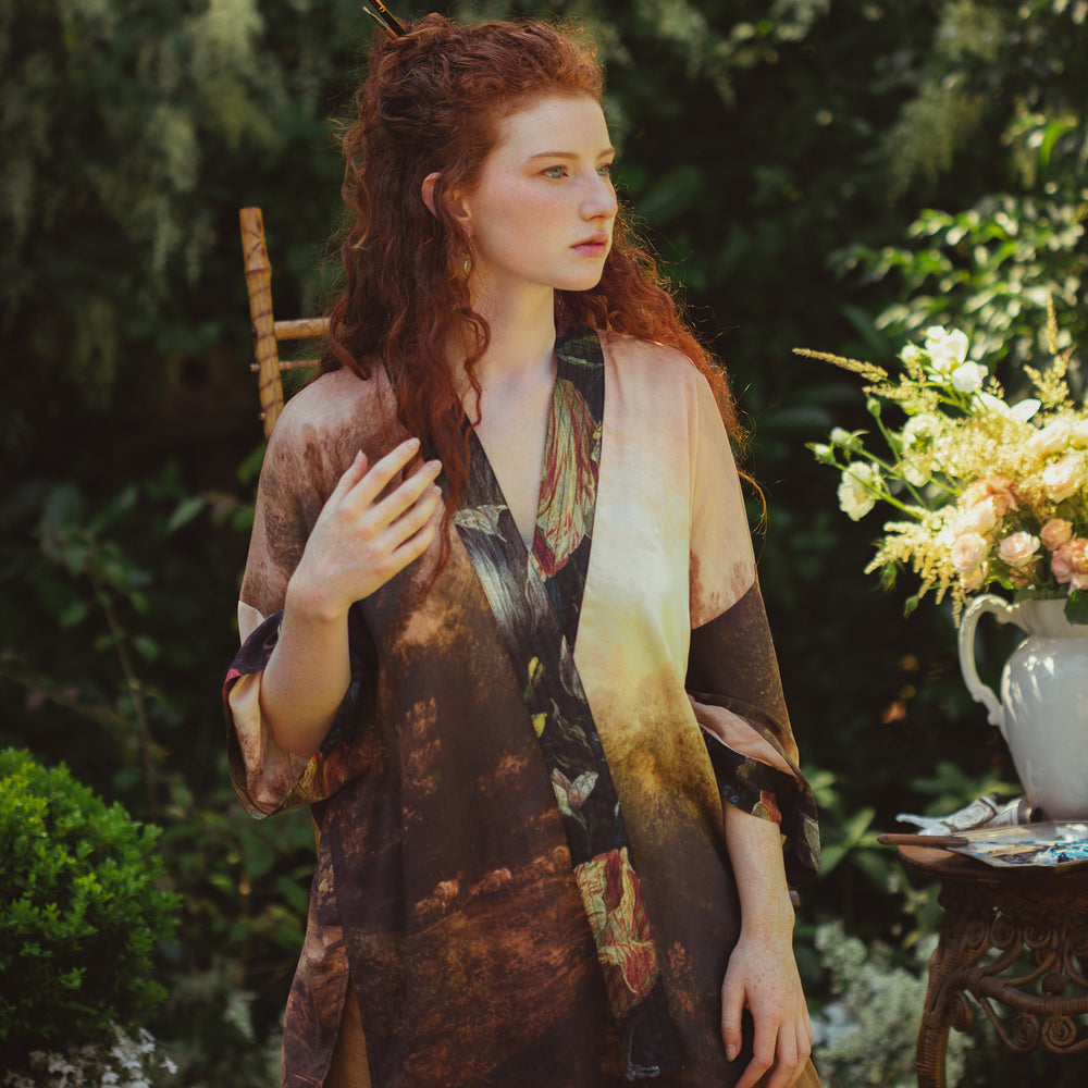 Model wearing The Artist kimono-style duster featuring antique paintings, botanical floral trim, and a radiant golden sun – Market of Stars