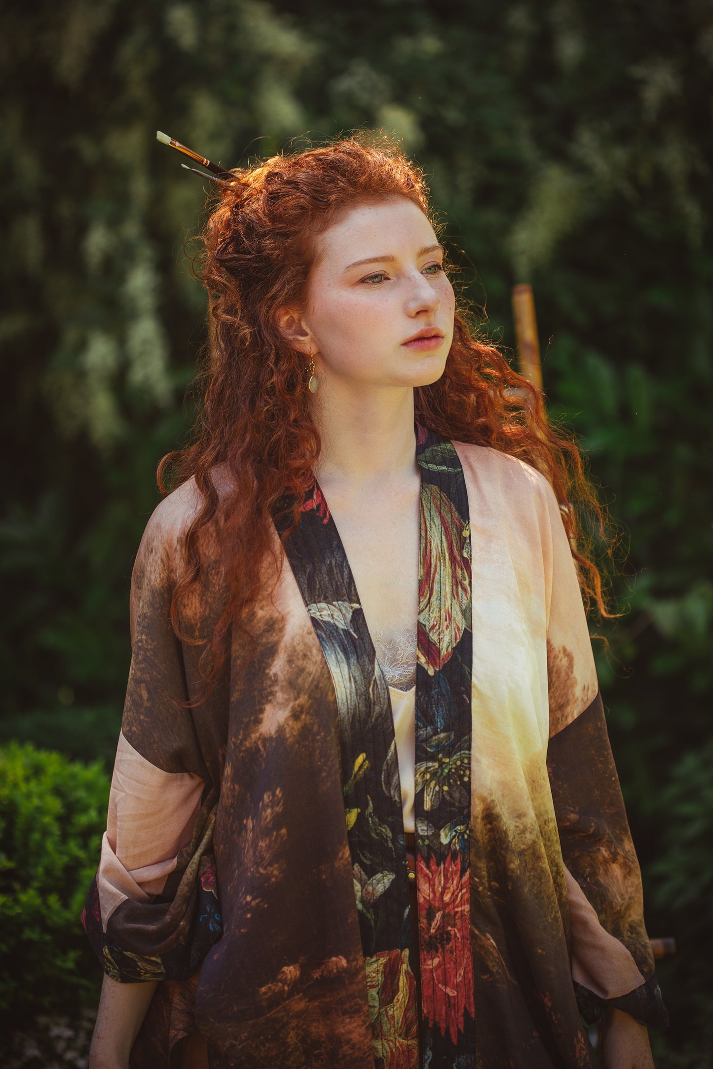 Model wearing The Artist kimono-style duster featuring antique paintings, botanical floral trim, and a radiant golden sun – Market of Stars