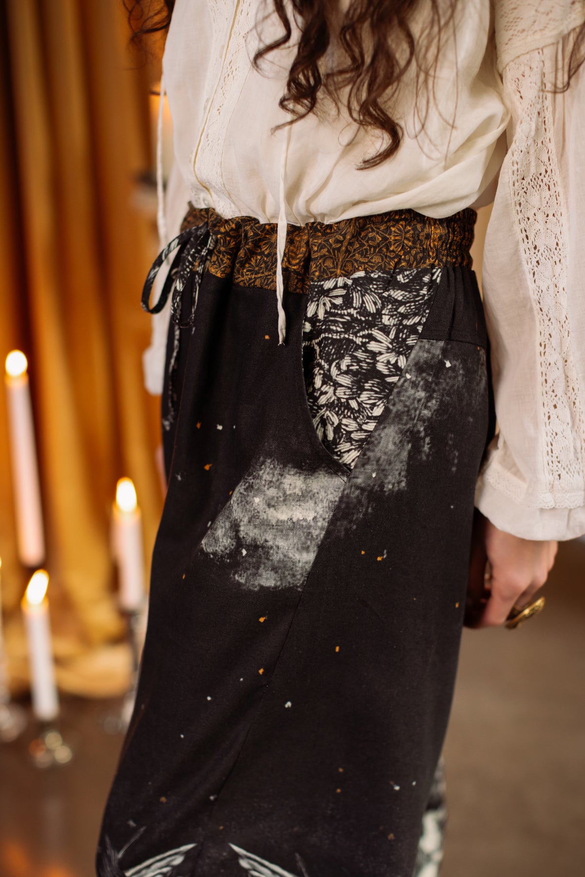 Model wearing a cropped linen blend pant with a celestial print ft. Burne-Jones angels, a moonlit sky, and vintage florals - Market of Stars.