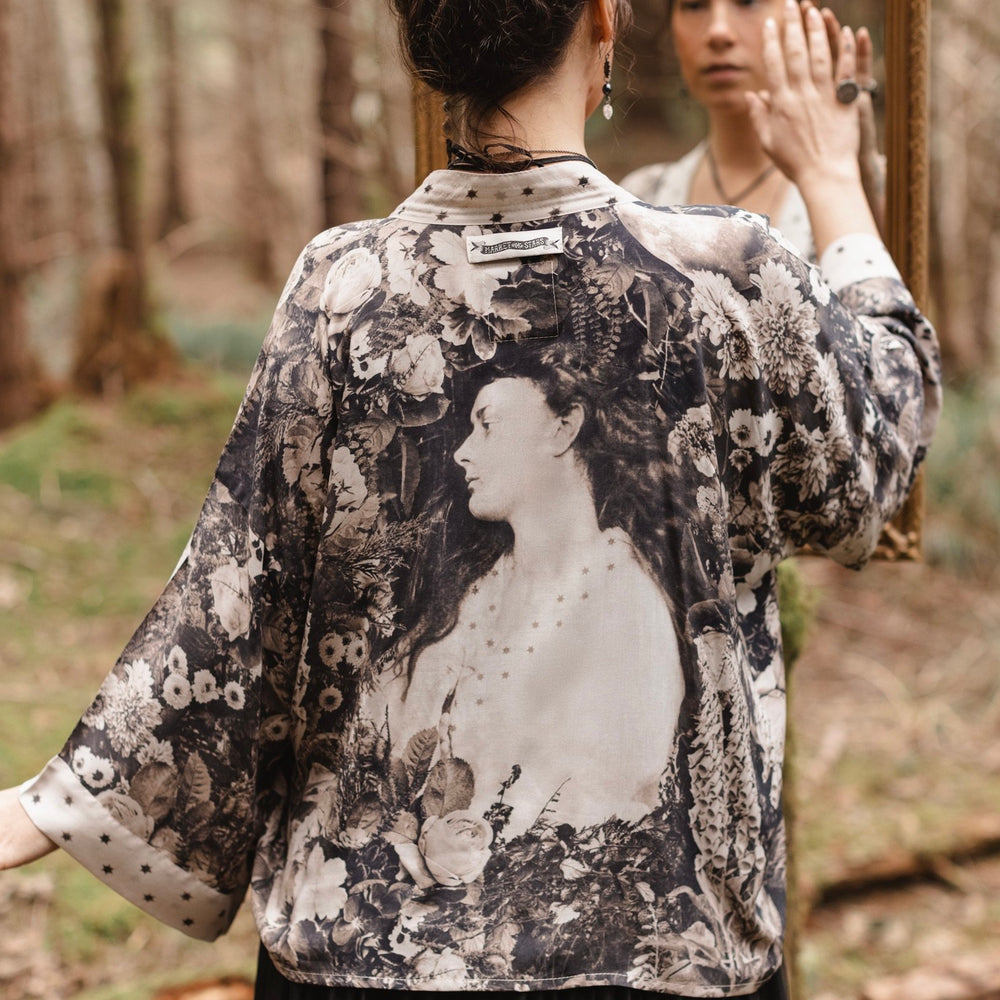 Model wearing Looking Glass Cropped Kimono featuring grown-up Alice Liddell, rare Victorian botanicals, and celestial star and moon accents inspired by Wonderland – Market of Stars.