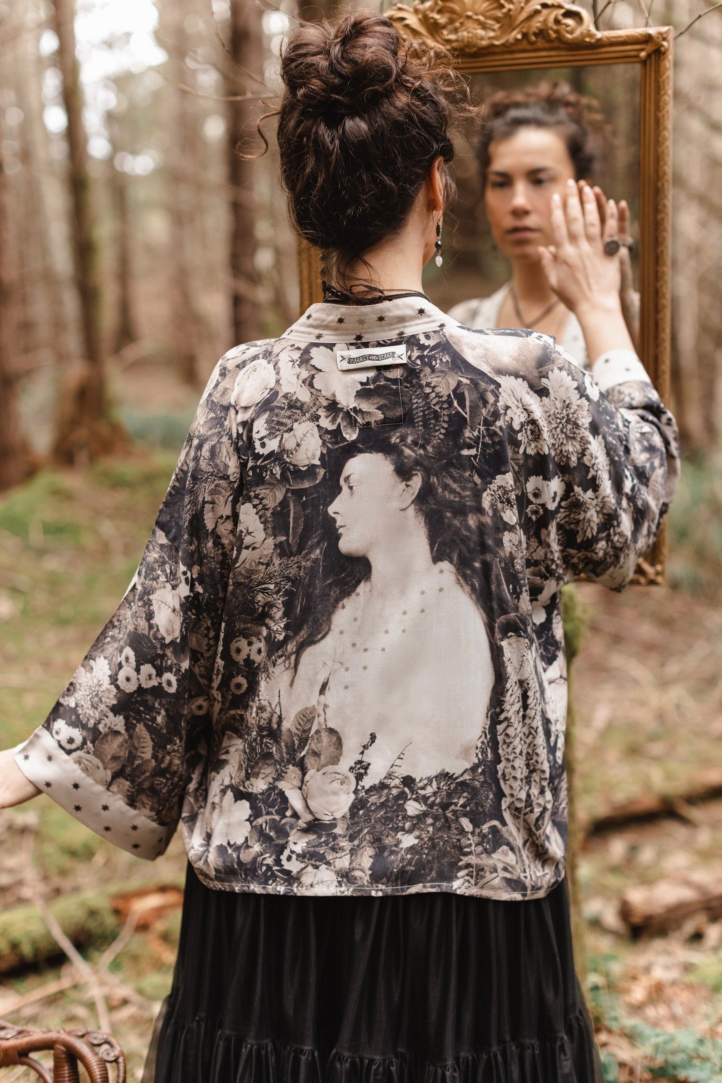 Model wearing Looking Glass Cropped Kimono featuring grown-up Alice Liddell, rare Victorian botanicals, and celestial star and moon accents inspired by Wonderland – Market of Stars.