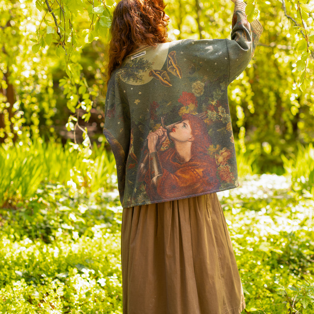 Model wearing a cozy cardigan lined with fleece featuring florals from centuries-old paintings and Rosetti’s iconic portrait of Joan of Arc - Market of Stars