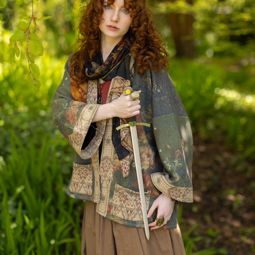 
                  
                    Model wearing a cozy cardigan lined with fleece featuring florals from centuries-old paintings and Rosetti’s iconic portrait of Joan of Arc - Market of Stars
                  
                