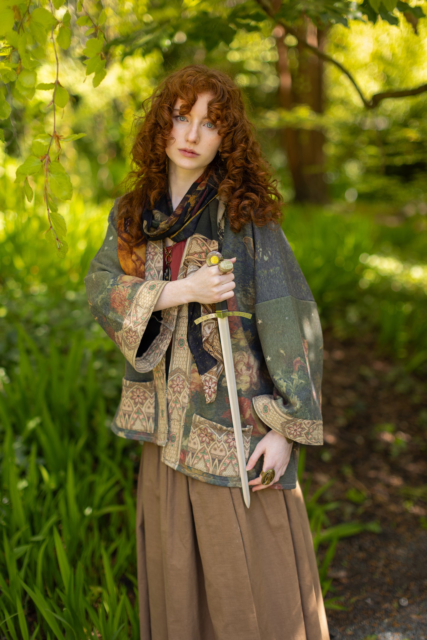 Model wearing a cozy cardigan lined with fleece featuring florals from centuries-old paintings and Rosetti’s iconic portrait of Joan of Arc - Market of Stars