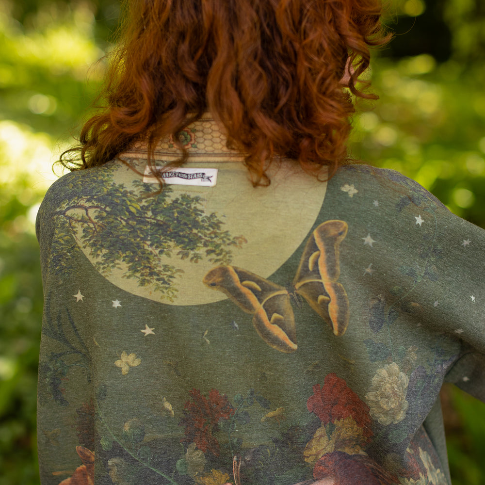 
                  
                    Model wearing a cozy cardigan lined with fleece featuring florals from centuries-old paintings and Rosetti’s iconic portrait of Joan of Arc - Market of Stars
                  
                