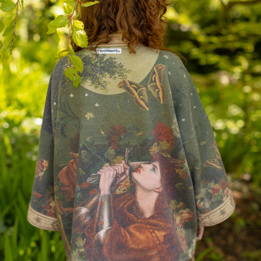 
                  
                    Model wearing a cozy cardigan lined with fleece featuring florals from centuries-old paintings and Rosetti’s iconic portrait of Joan of Arc - Market of Stars
                  
                