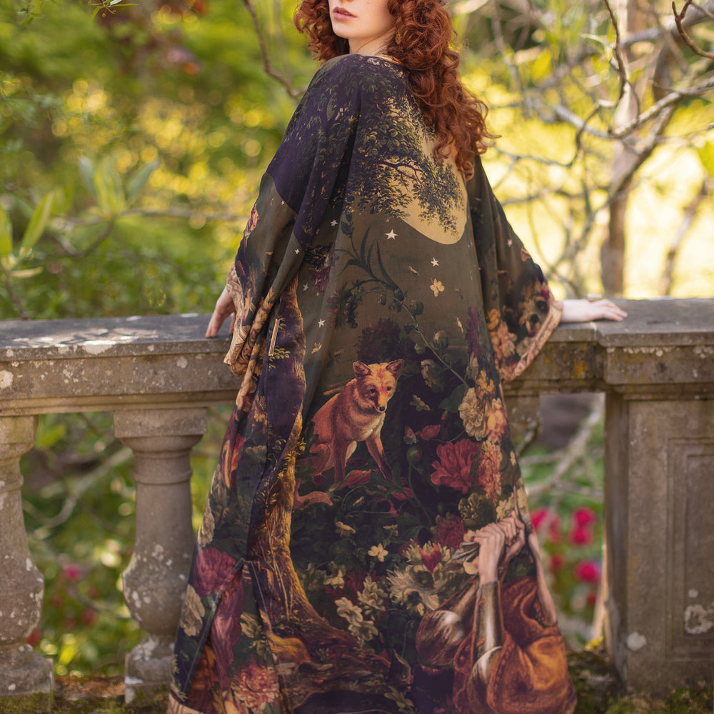 Model wearing a full-length bamboo-viscose duster featuring florals from centuries-old paintings and Rosetti’s iconic portrait of Joan of Arc - Market of Stars