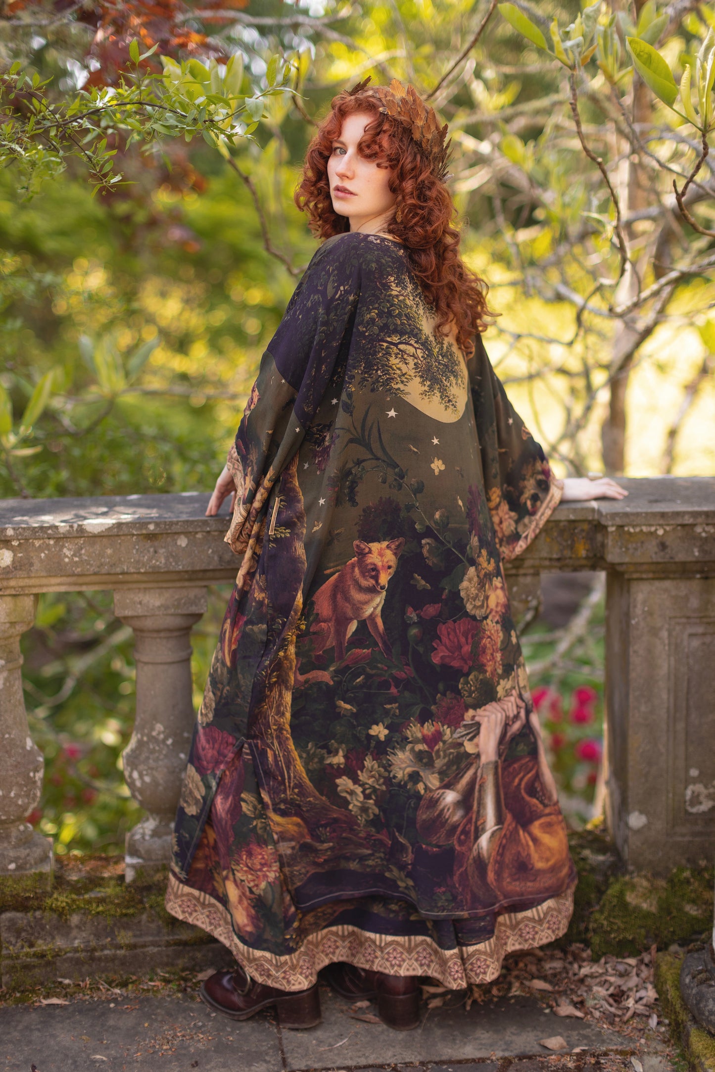 Model wearing a full-length bamboo-viscose duster featuring florals from centuries-old paintings and Rosetti’s iconic portrait of Joan of Arc - Market of Stars