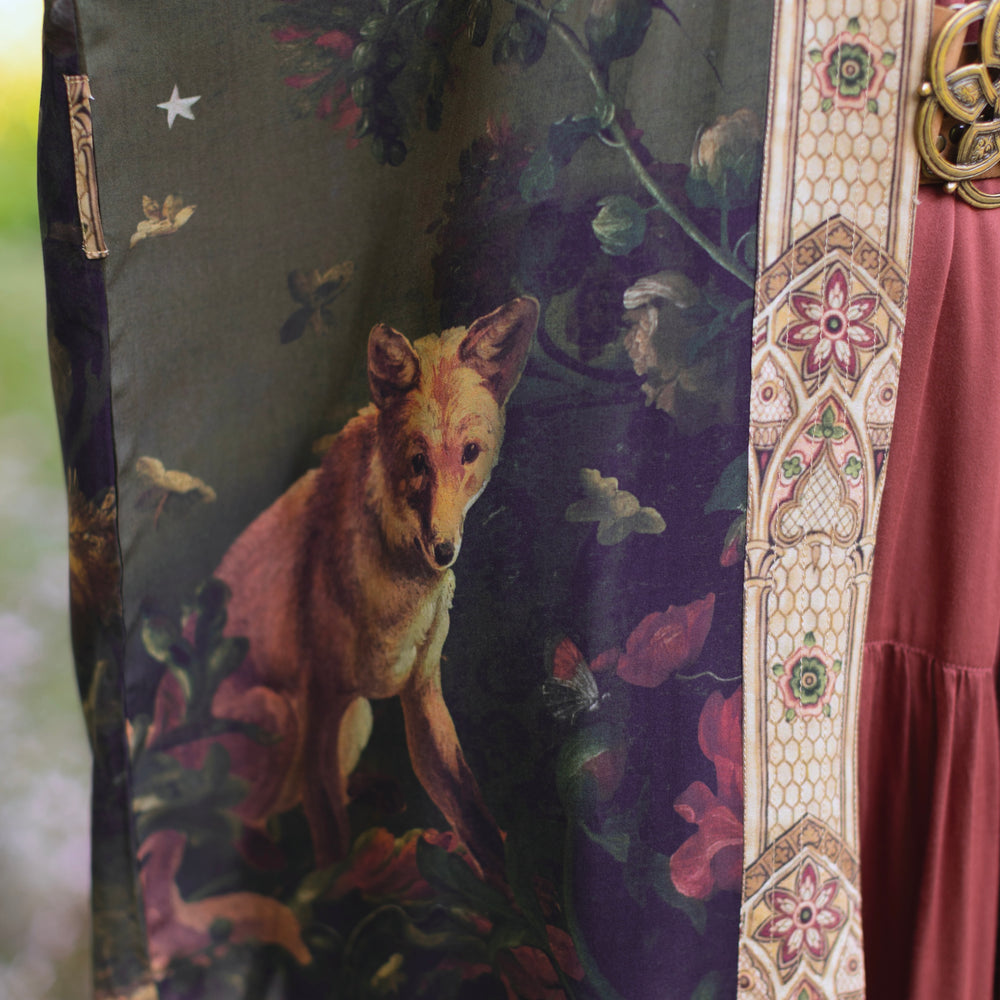 
                  
                    Model wearing a full-length bamboo-viscose duster featuring florals from centuries-old paintings and Rosetti’s iconic portrait of Joan of Arc - Market of Stars
                  
                