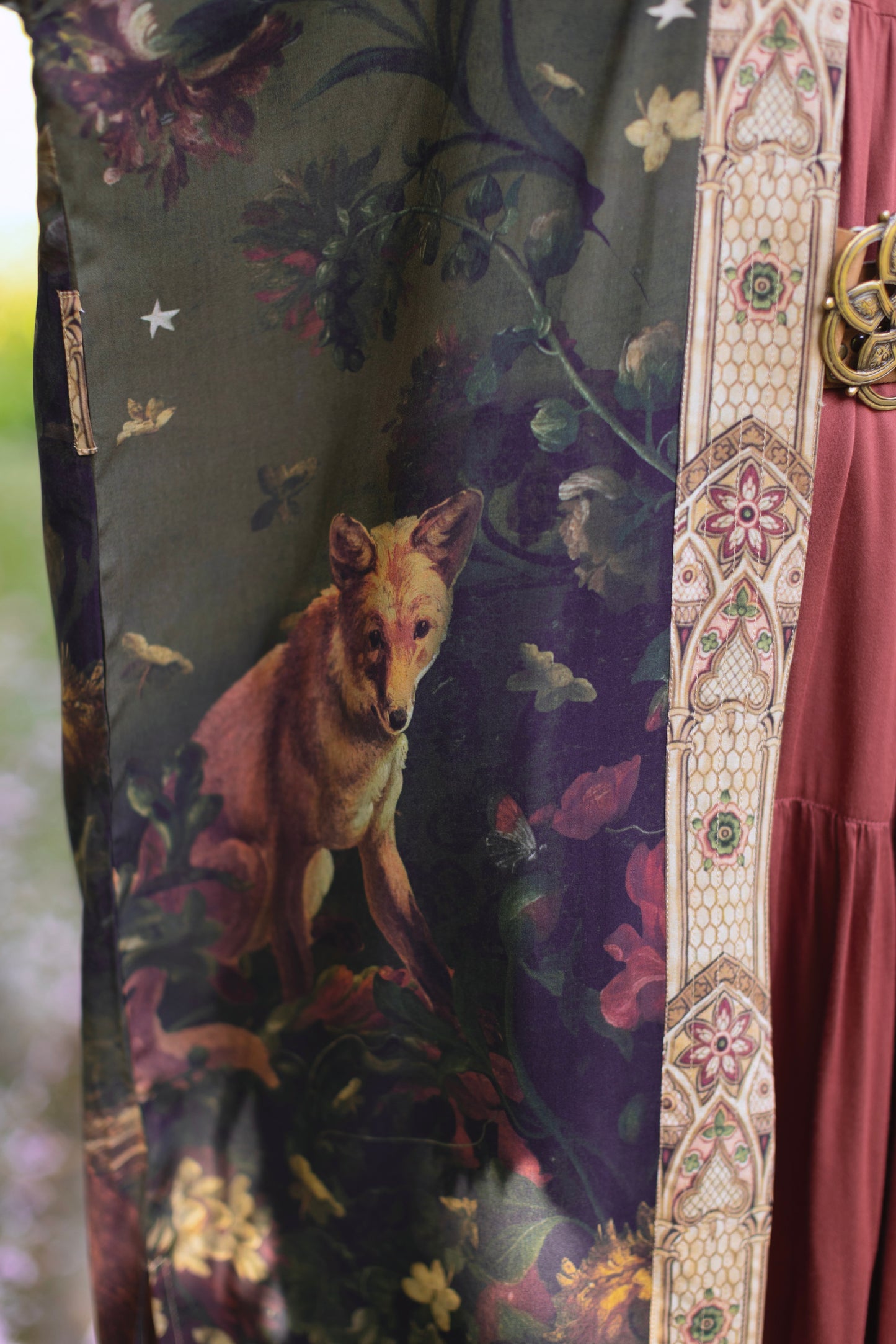Model wearing a full-length bamboo-viscose duster featuring florals from centuries-old paintings and Rosetti’s iconic portrait of Joan of Arc - Market of Stars