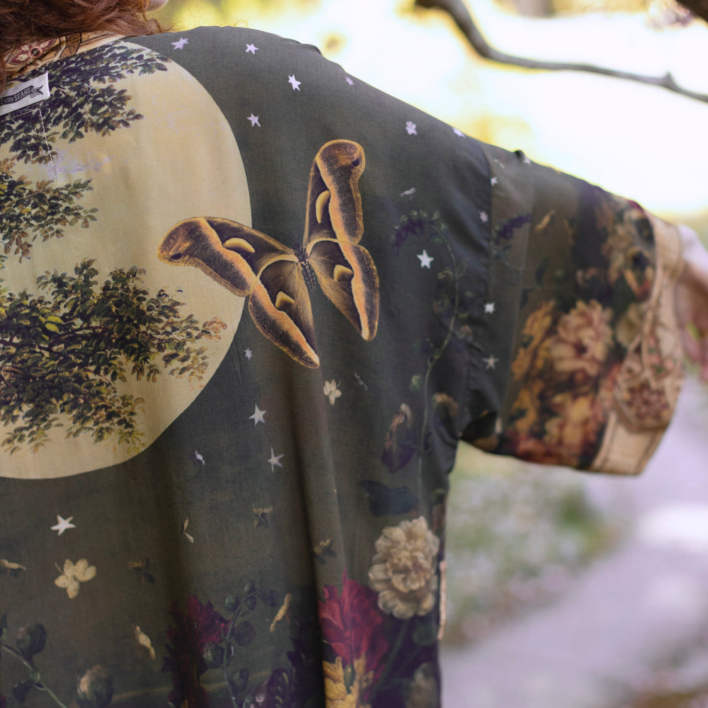
                  
                    Model wearing a full-length bamboo-viscose duster featuring florals from centuries-old paintings and Rosetti’s iconic portrait of Joan of Arc - Market of Stars
                  
                