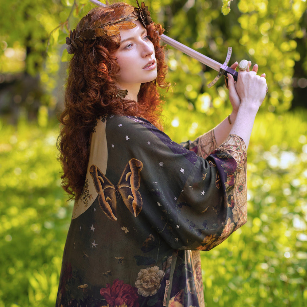 
                  
                    Model wearing a full-length bamboo-viscose duster featuring florals from centuries-old paintings and Rosetti’s iconic portrait of Joan of Arc - Market of Stars
                  
                