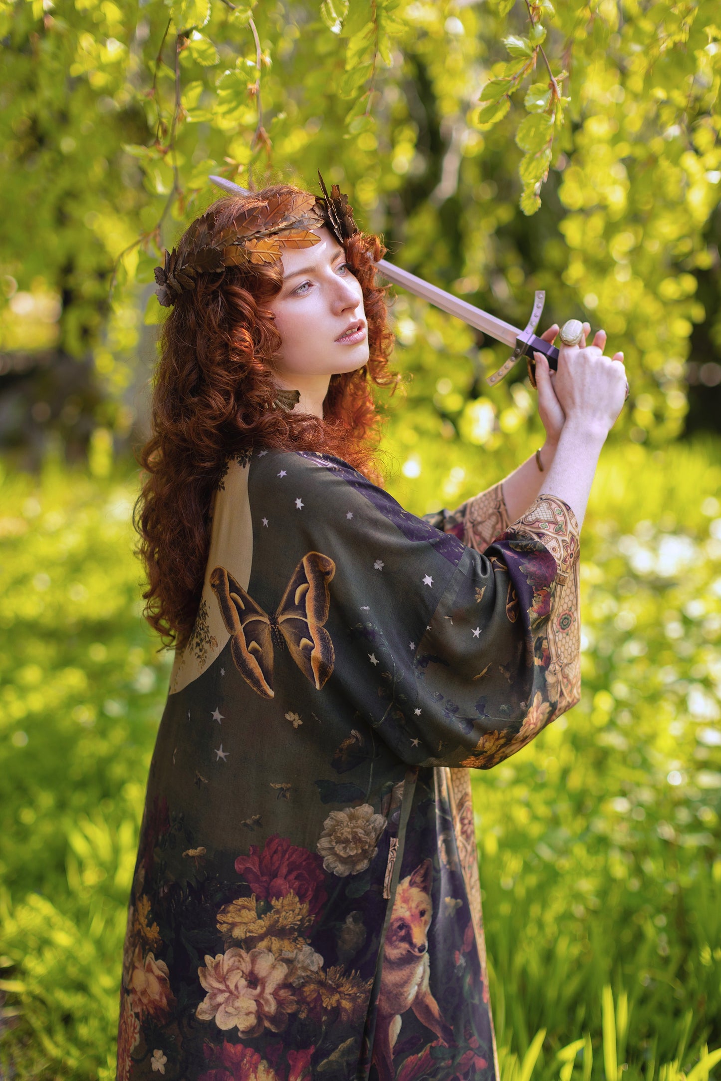 Model wearing a full-length bamboo-viscose duster featuring florals from centuries-old paintings and Rosetti’s iconic portrait of Joan of Arc - Market of Stars