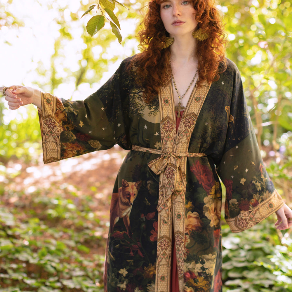 
                  
                    Model wearing a full-length bamboo-viscose duster featuring florals from centuries-old paintings and Rosetti’s iconic portrait of Joan of Arc - Market of Stars
                  
                