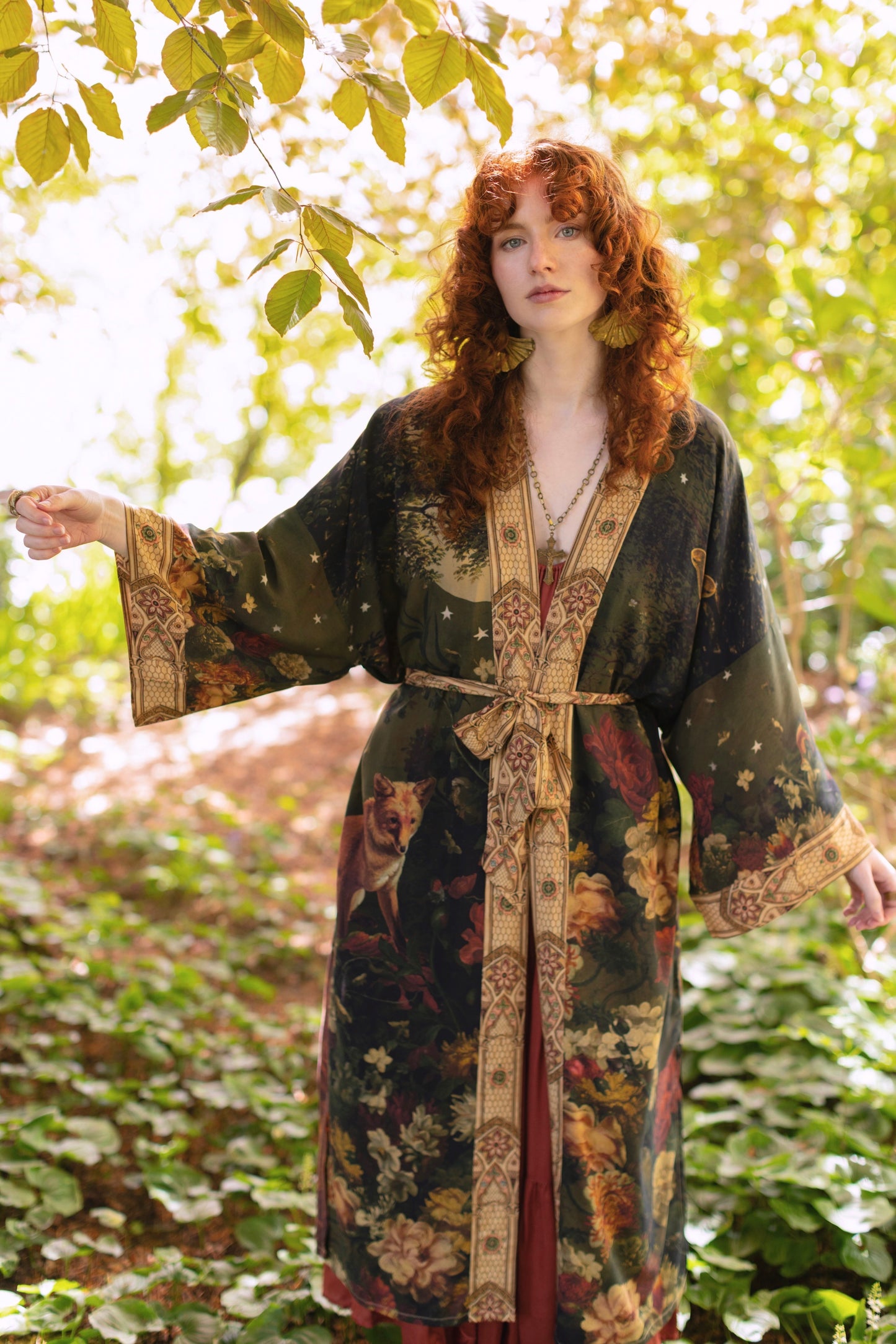 Model wearing a full-length bamboo-viscose duster featuring florals from centuries-old paintings and Rosetti’s iconic portrait of Joan of Arc - Market of Stars