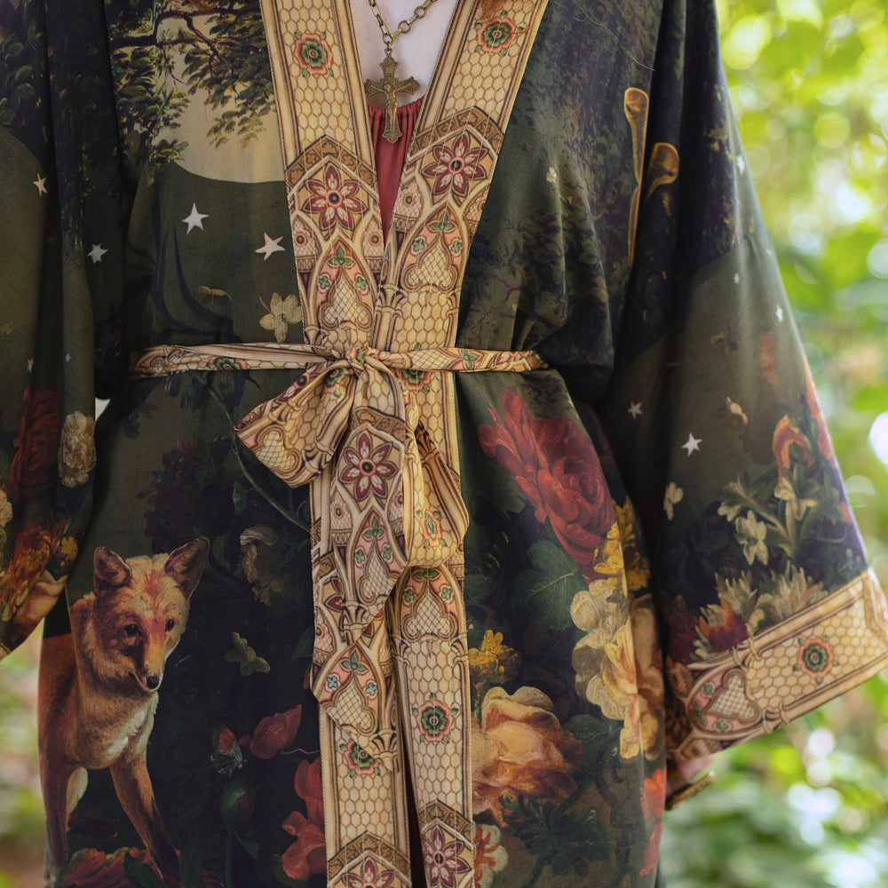 
                  
                    Model wearing a full-length bamboo-viscose duster featuring florals from centuries-old paintings and Rosetti’s iconic portrait of Joan of Arc - Market of Stars
                  
                