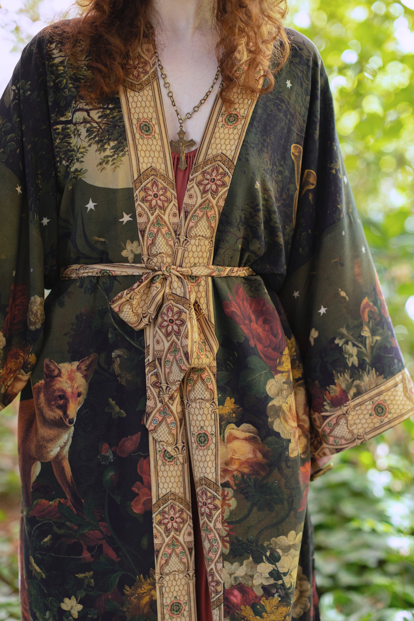 Model wearing a full-length bamboo-viscose duster featuring florals from centuries-old paintings and Rosetti’s iconic portrait of Joan of Arc - Market of Stars
