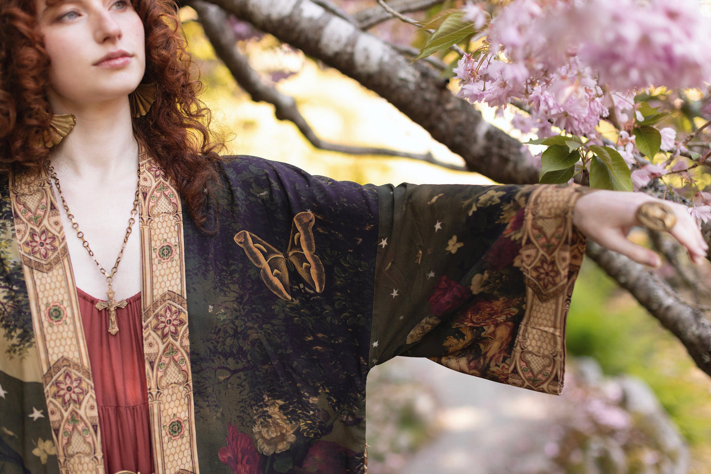 Model wearing a full-length bamboo-viscose duster featuring florals from centuries-old paintings and Rosetti’s iconic portrait of Joan of Arc - Market of Stars