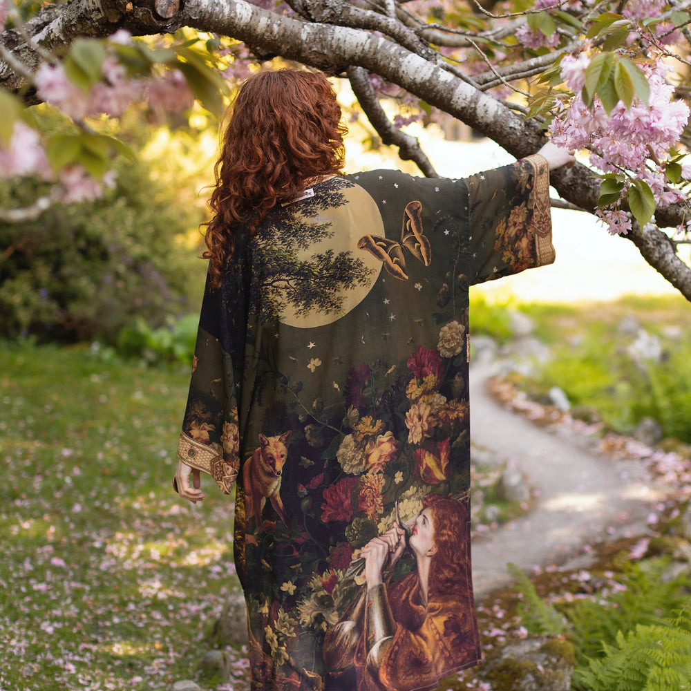 
                  
                    Model wearing a full-length bamboo-viscose duster featuring florals from centuries-old paintings and Rosetti’s iconic portrait of Joan of Arc - Market of Stars
                  
                
