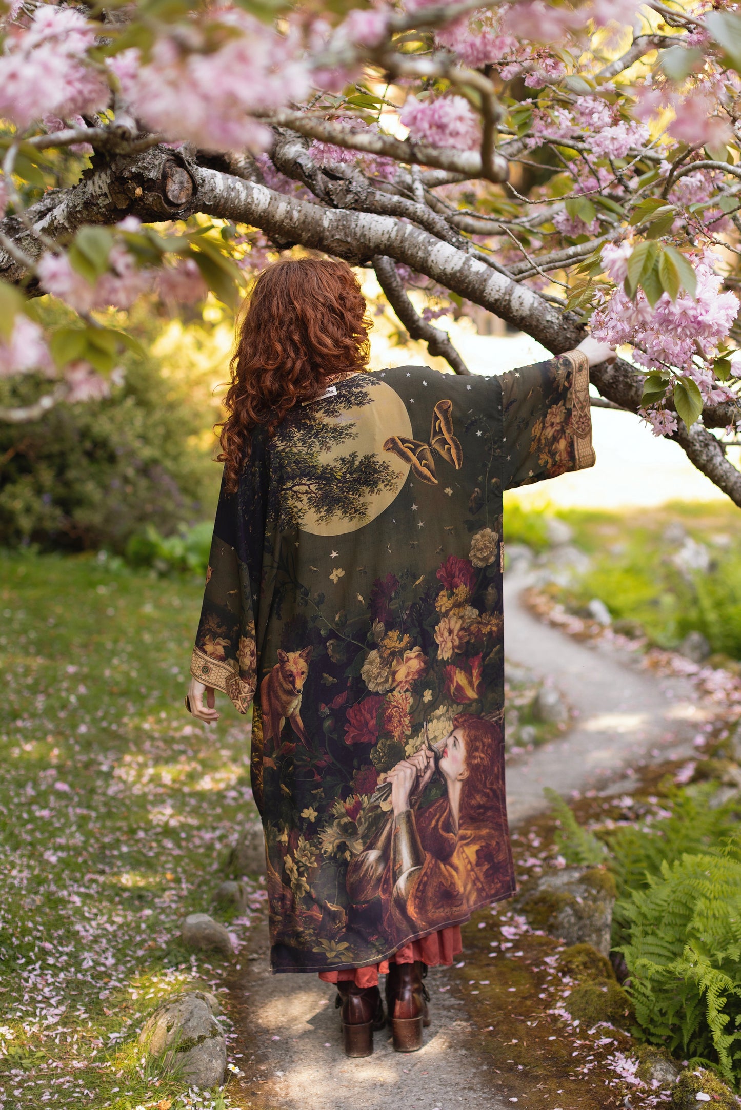 Model wearing a full-length bamboo-viscose duster featuring florals from centuries-old paintings and Rosetti’s iconic portrait of Joan of Arc - Market of Stars