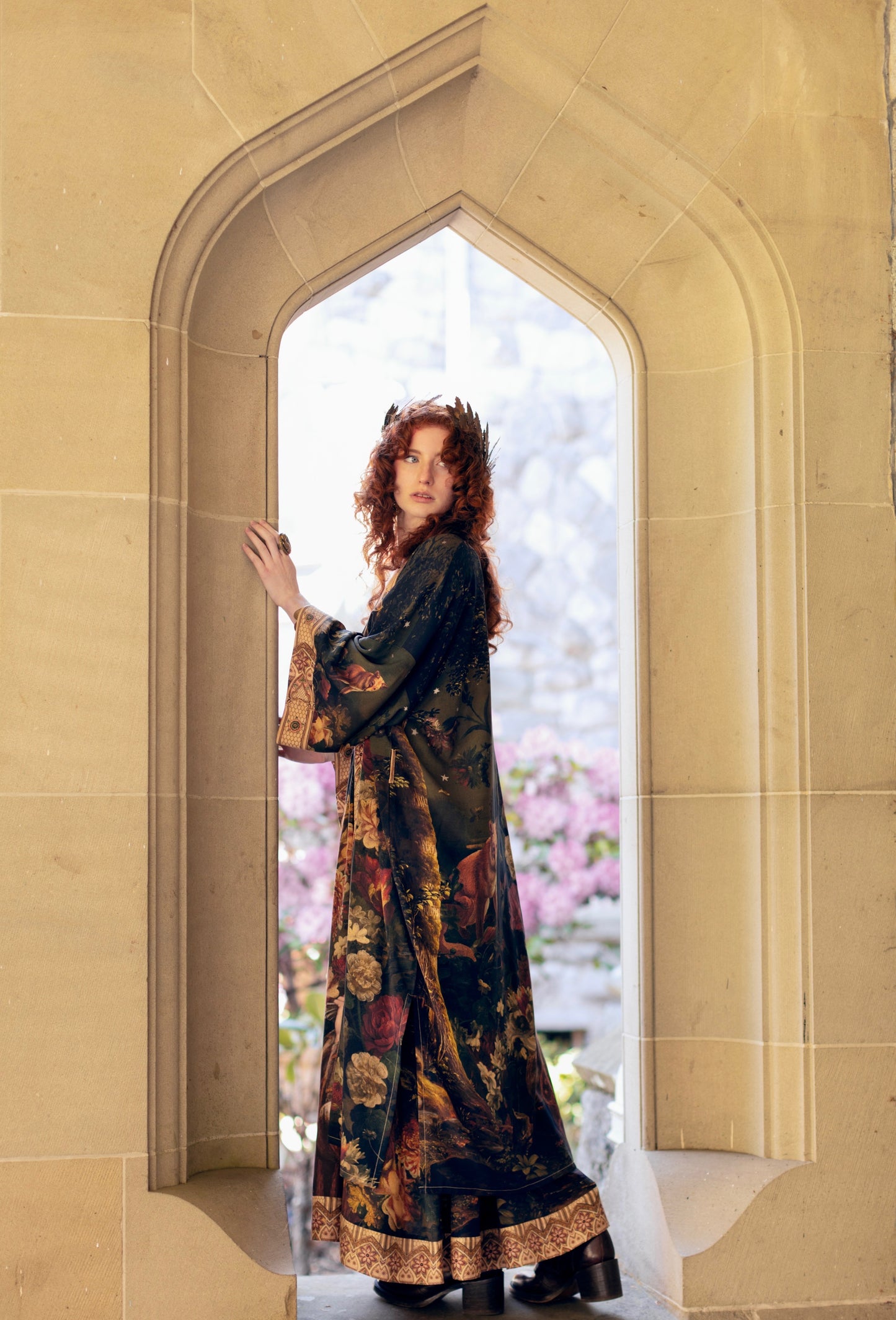Model wearing a full-length bamboo-viscose duster featuring florals from centuries-old paintings and Rosetti’s iconic portrait of Joan of Arc - Market of Stars