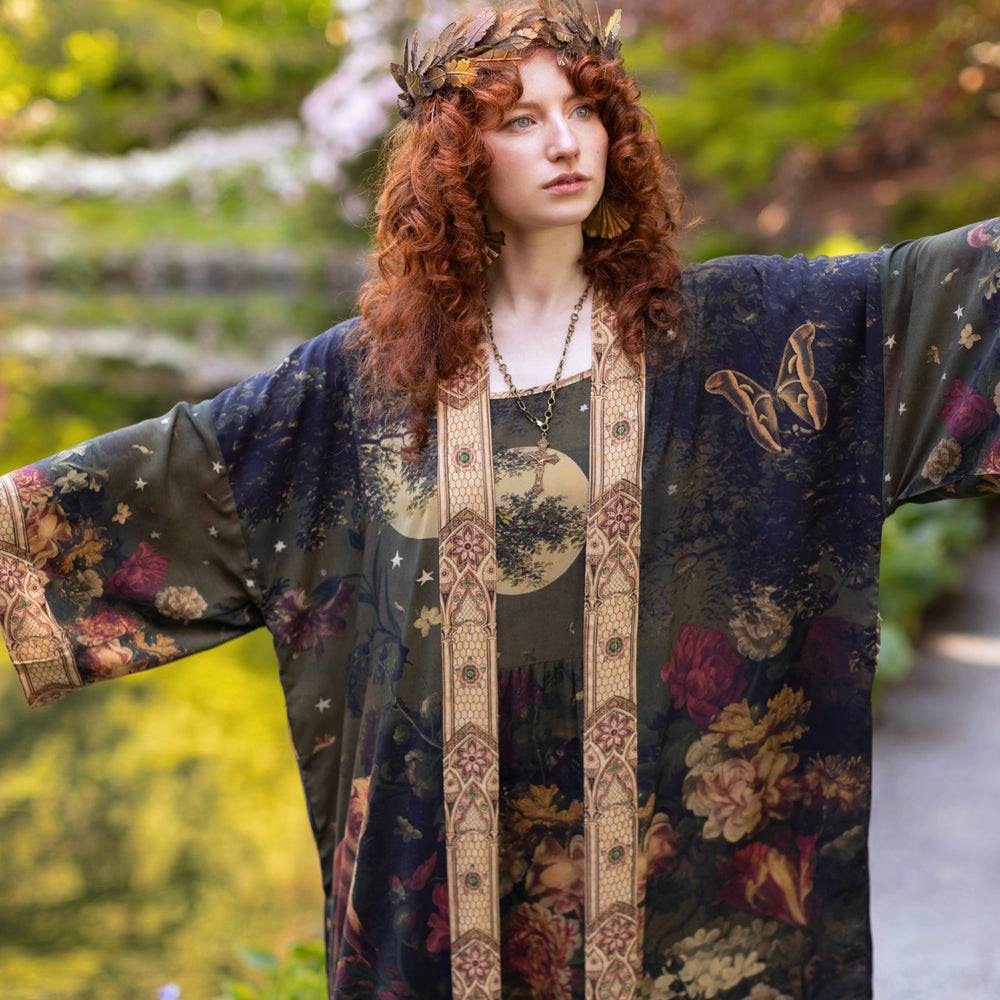 Model wearing a full-length bamboo-viscose duster featuring florals from centuries-old paintings and Rosetti’s iconic portrait of Joan of Arc - Market of Stars