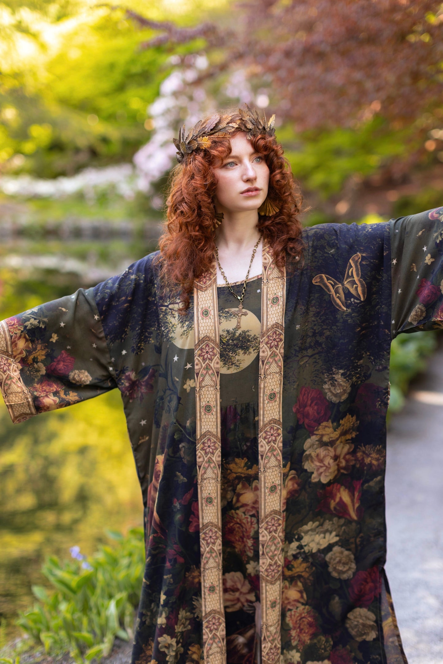Model wearing a full-length bamboo-viscose duster featuring florals from centuries-old paintings and Rosetti’s iconic portrait of Joan of Arc - Market of Stars