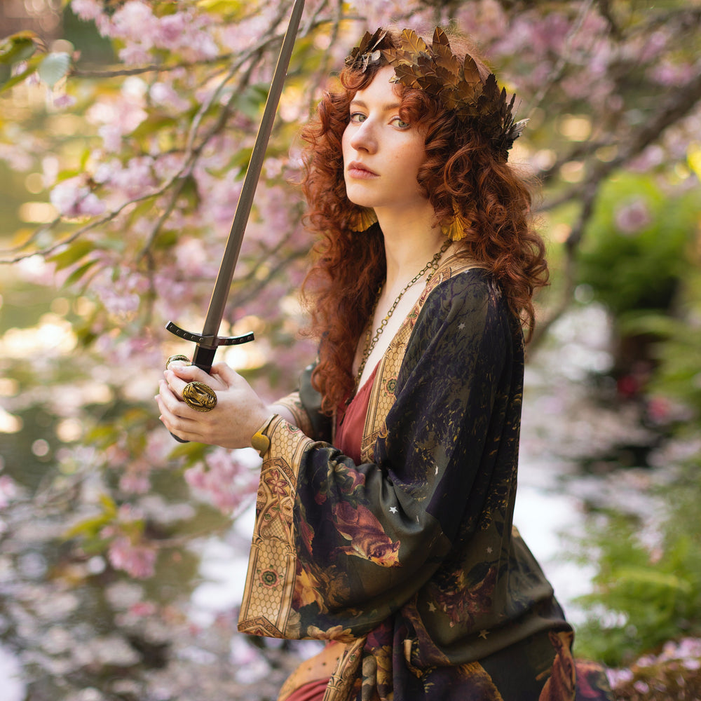 
                  
                    Model wearing a full-length bamboo-viscose duster featuring florals from centuries-old paintings and Rosetti’s iconic portrait of Joan of Arc - Market of Stars
                  
                