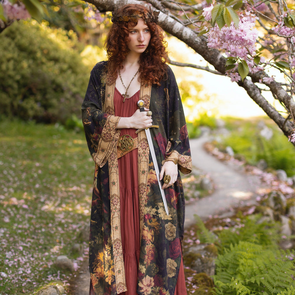 
                  
                    Model wearing a full-length bamboo-viscose duster featuring florals from centuries-old paintings and Rosetti’s iconic portrait of Joan of Arc - Market of Stars
                  
                