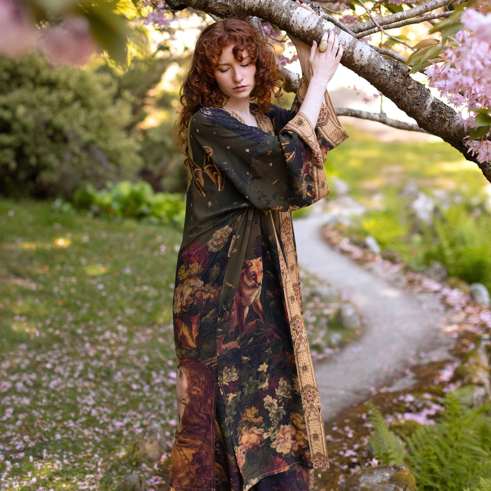 
                  
                    Model wearing a full-length bamboo-viscose duster featuring florals from centuries-old paintings and Rosetti’s iconic portrait of Joan of Arc - Market of Stars
                  
                
