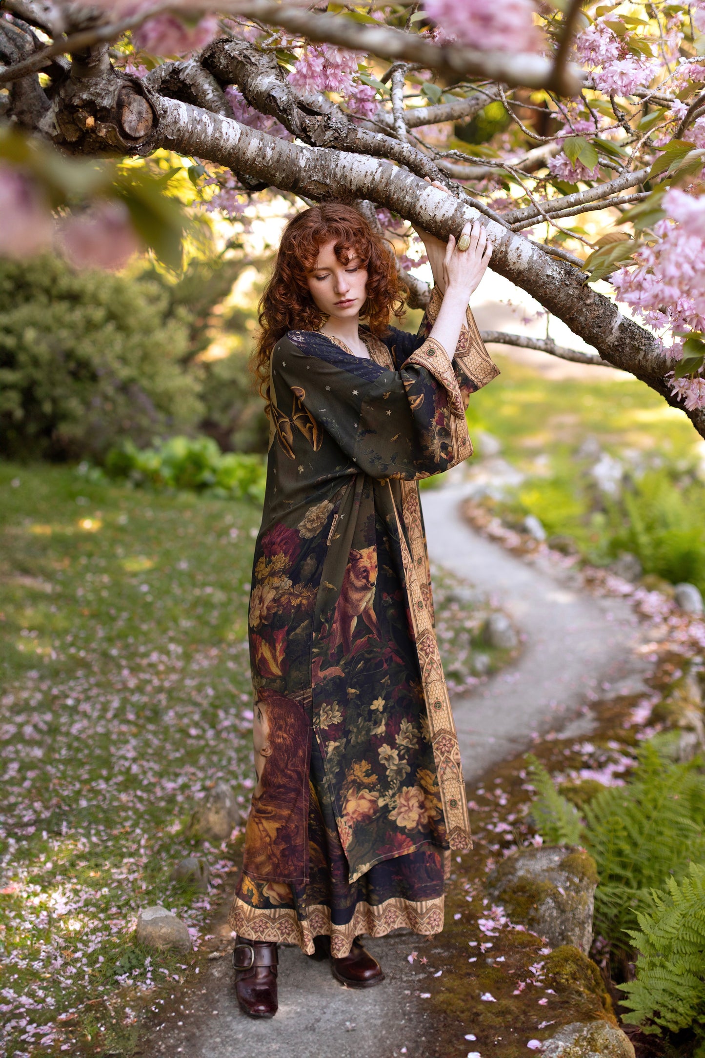 Model wearing a full-length bamboo-viscose duster featuring florals from centuries-old paintings and Rosetti’s iconic portrait of Joan of Arc - Market of Stars