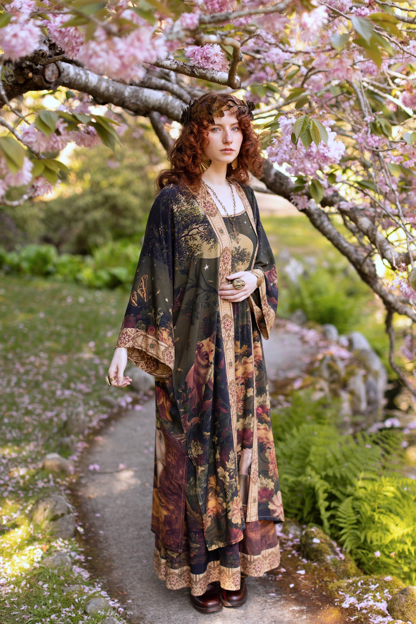 Model wearing a full-length bamboo-viscose duster featuring florals from centuries-old paintings and Rosetti’s iconic portrait of Joan of Arc - Market of Stars