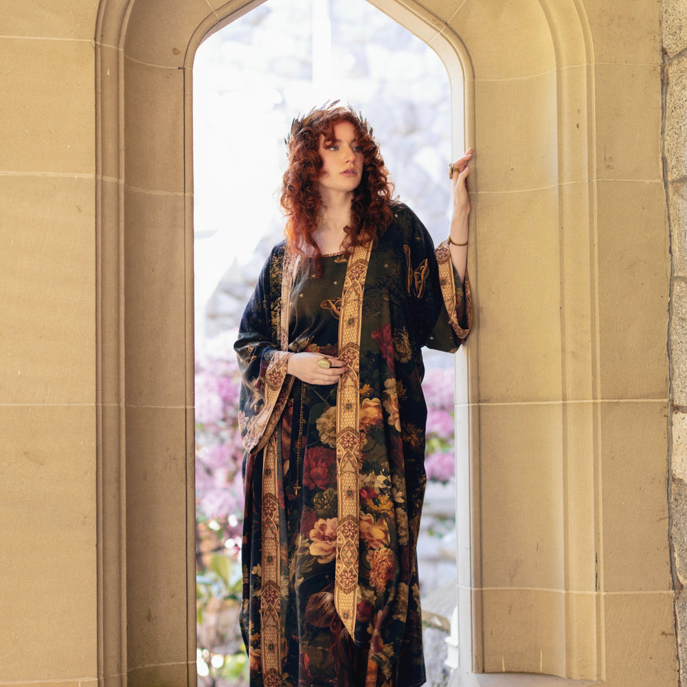 
                  
                    Model wearing a full-length bamboo-viscose duster featuring florals from centuries-old paintings and Rosetti’s iconic portrait of Joan of Arc - Market of Stars
                  
                
