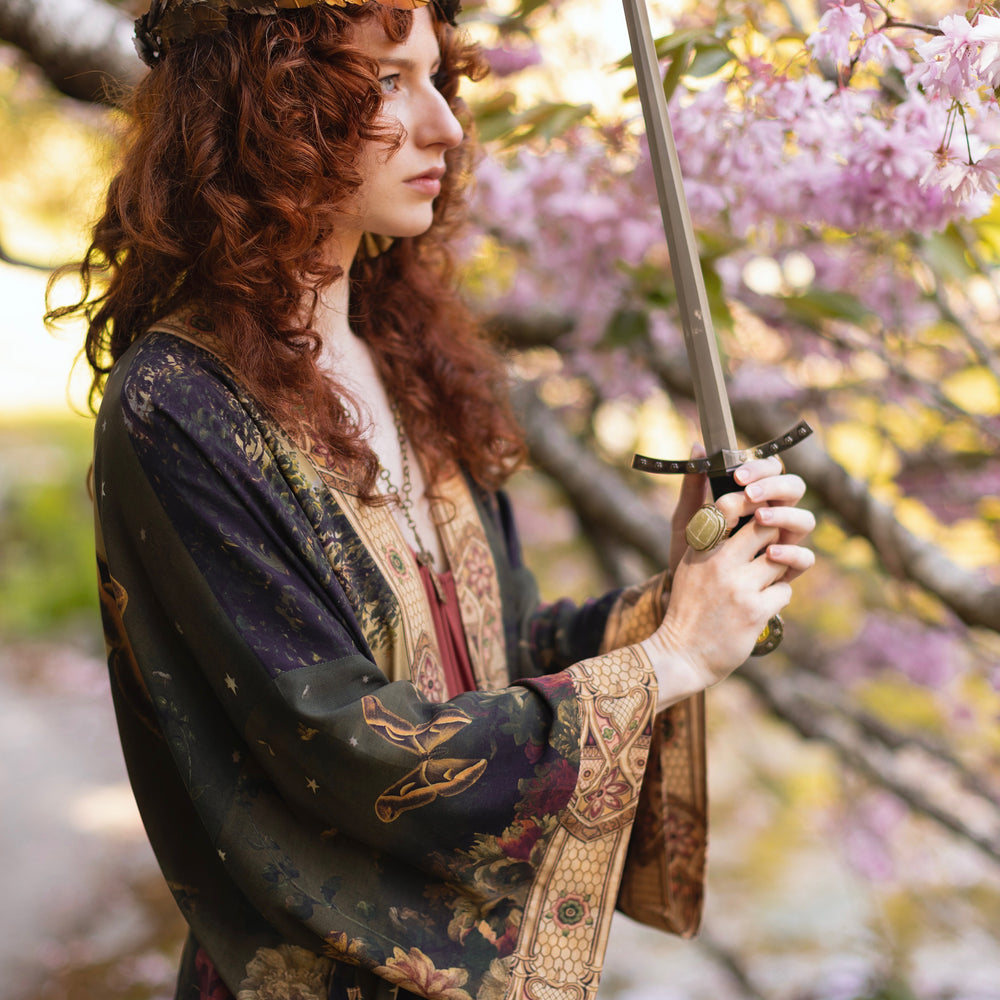 
                  
                    Model wearing a full-length bamboo-viscose duster featuring florals from centuries-old paintings and Rosetti’s iconic portrait of Joan of Arc - Market of Stars
                  
                