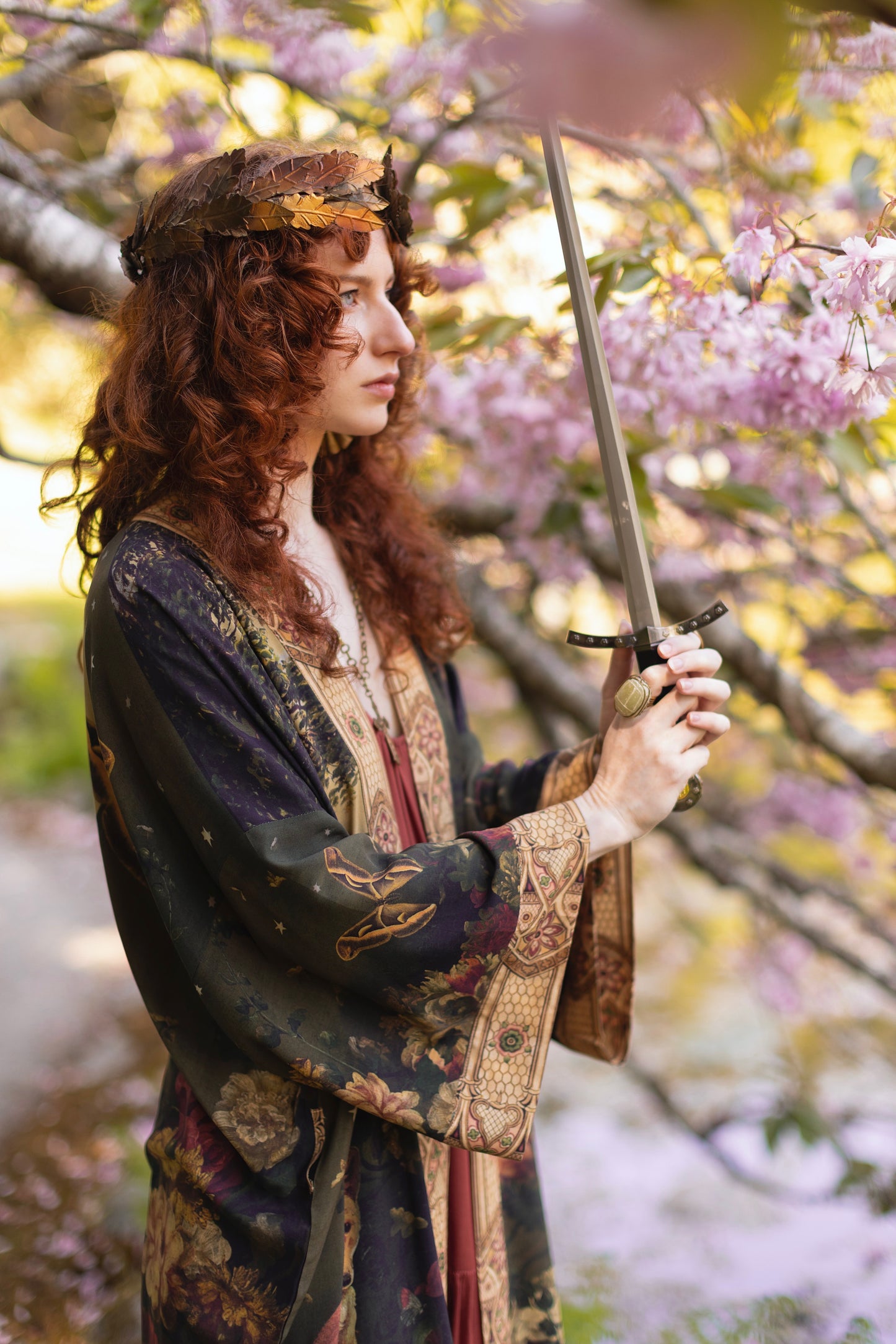 Model wearing a full-length bamboo-viscose duster featuring florals from centuries-old paintings and Rosetti’s iconic portrait of Joan of Arc - Market of Stars
