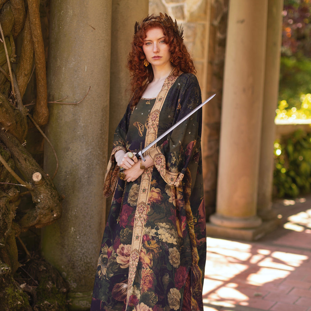
                  
                    Model wearing a full-length bamboo-viscose duster featuring florals from centuries-old paintings and Rosetti’s iconic portrait of Joan of Arc - Market of Stars
                  
                